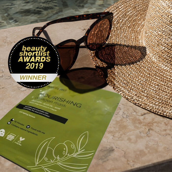 A nourishing sheet mask on the side of a swimming pool with a pair of sunglasses and a sun hut. A badge that shows an award win: beauty shortlist awards 2019 winner.