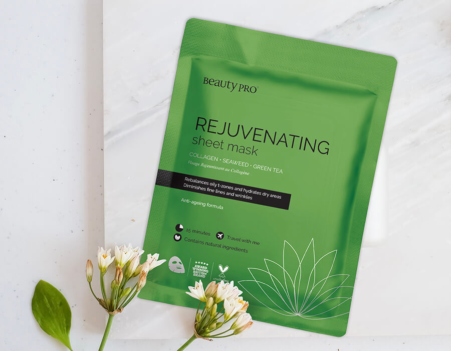 The rejuvenating mask packaging on a marble background with white flowers overlaid
